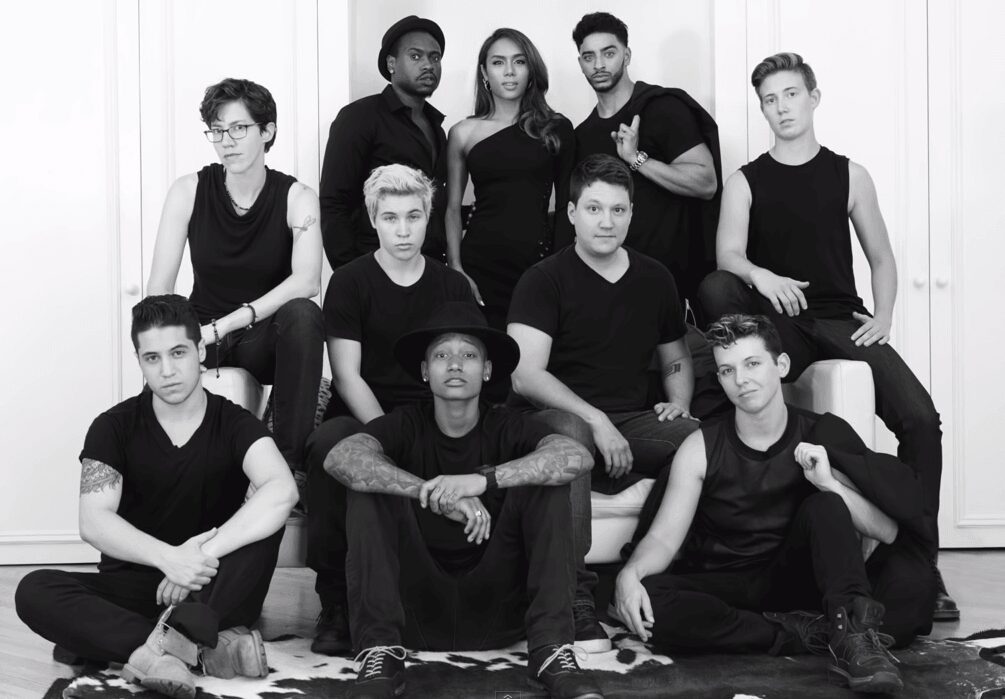 Black and white group portrait of diverse young adults in casual clothing.
