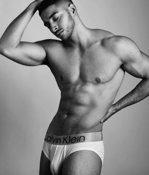 Black and white photo of a muscular man in Calvin Klein underwear.