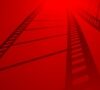 Red background with black filmstrip shadows creating a cinematic effect.