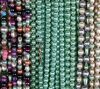 Close-up of colorful and shiny beaded necklaces.