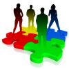 Four colorful puzzle pieces with four silhouetted people standing on each piece.