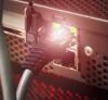 Ethernet cable plugged into a device port with LED indicator.