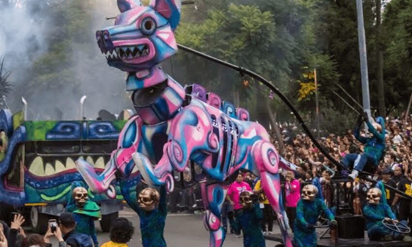 Colorful mechanical creature puppet operated by performers in a parade.