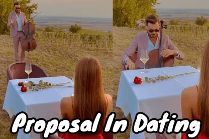 A man proposes to a woman during a date at an outdoor table with a scenic view.